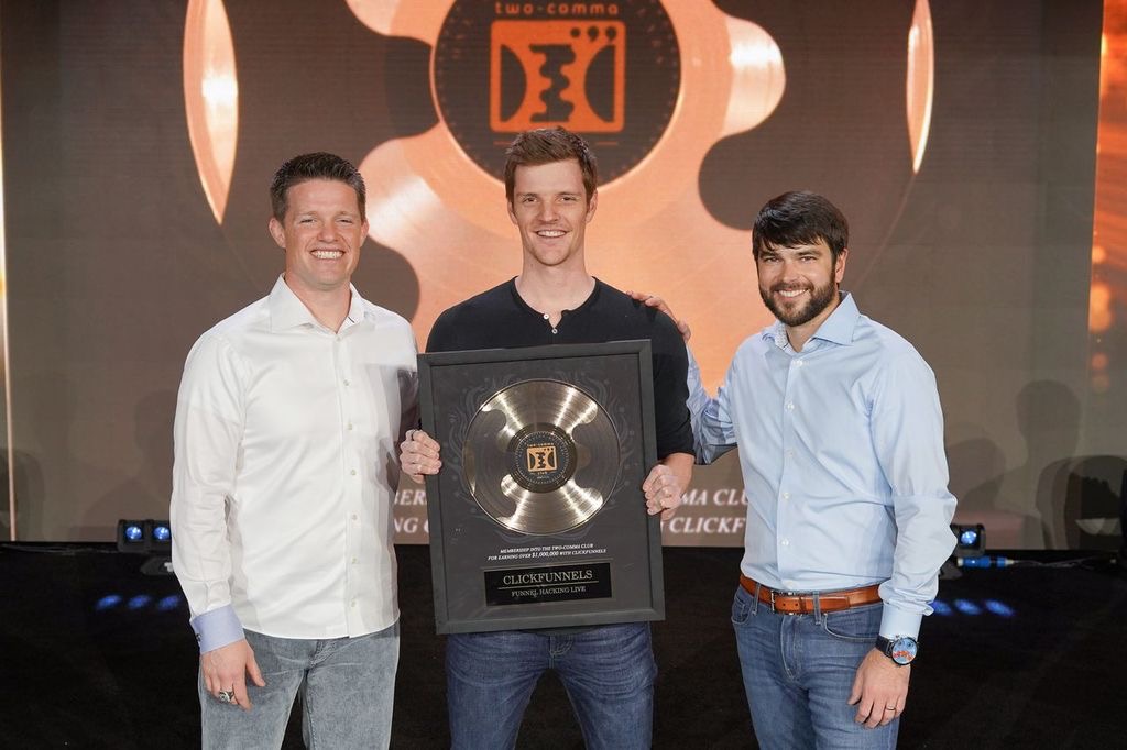 Christian receiving a Two Comma Club award in 2019